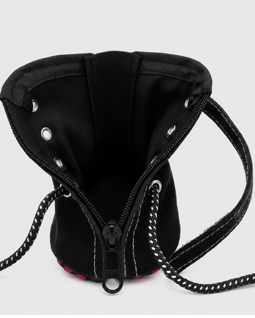 Black drawstring bag with chain detail on a white background