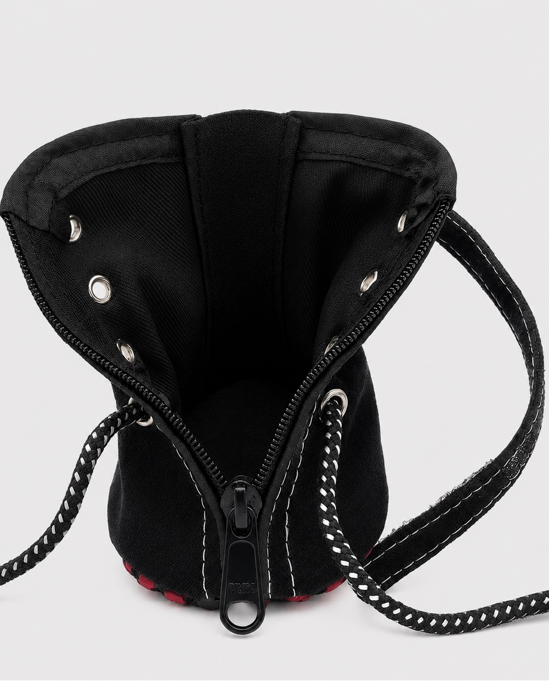 Black drawstring bag with chain detail on a white background